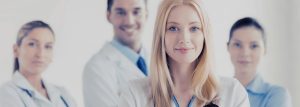 Focused in on female medical consultant, with 3 in the background