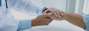 Medical consultant and client shaking hands